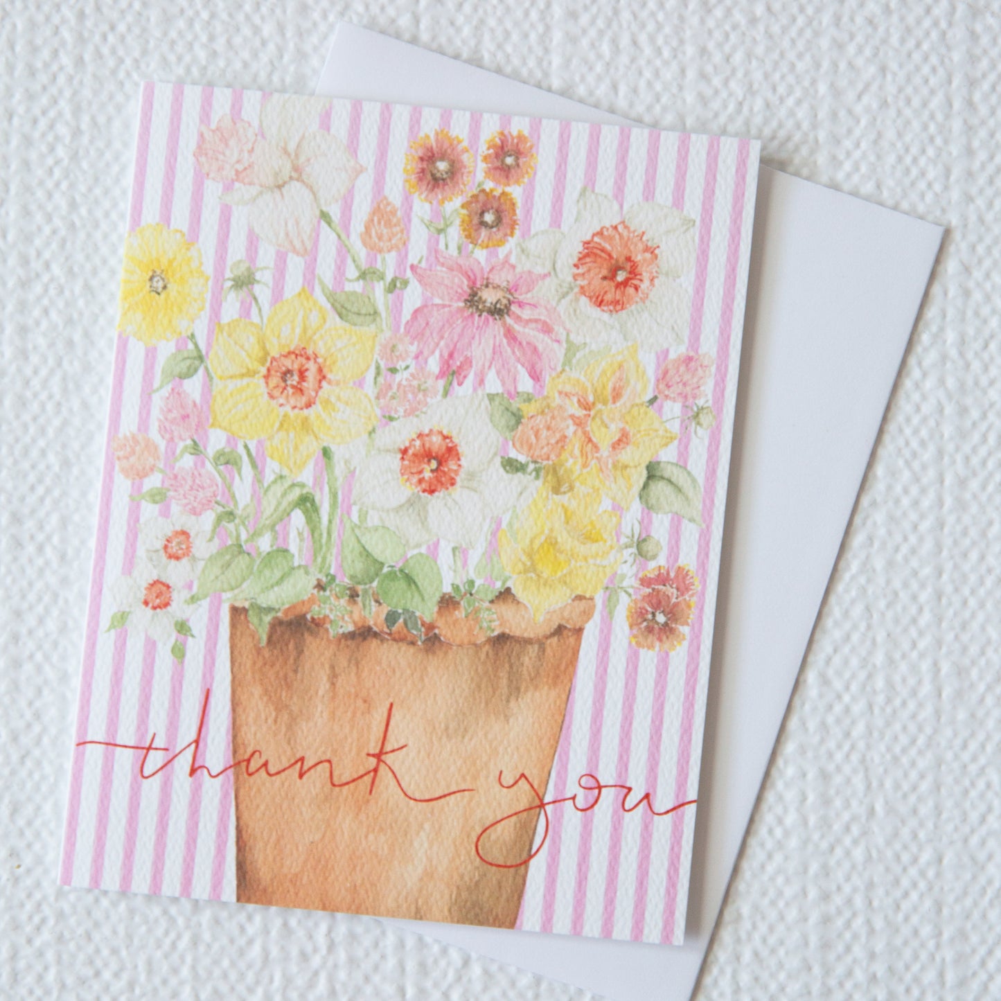 Greeting card with floral design and 'thank you' text on a striped background