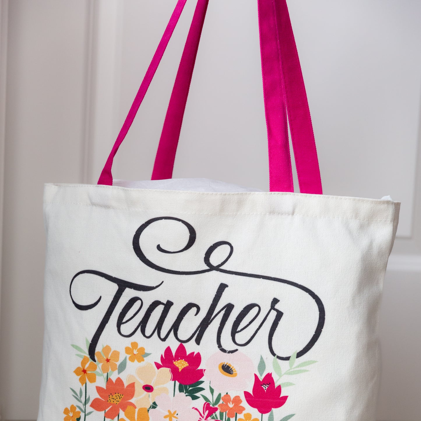 Tote bag with 'Teacher' text and floral design on a white background